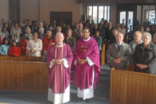 Father Harrington with congregation
